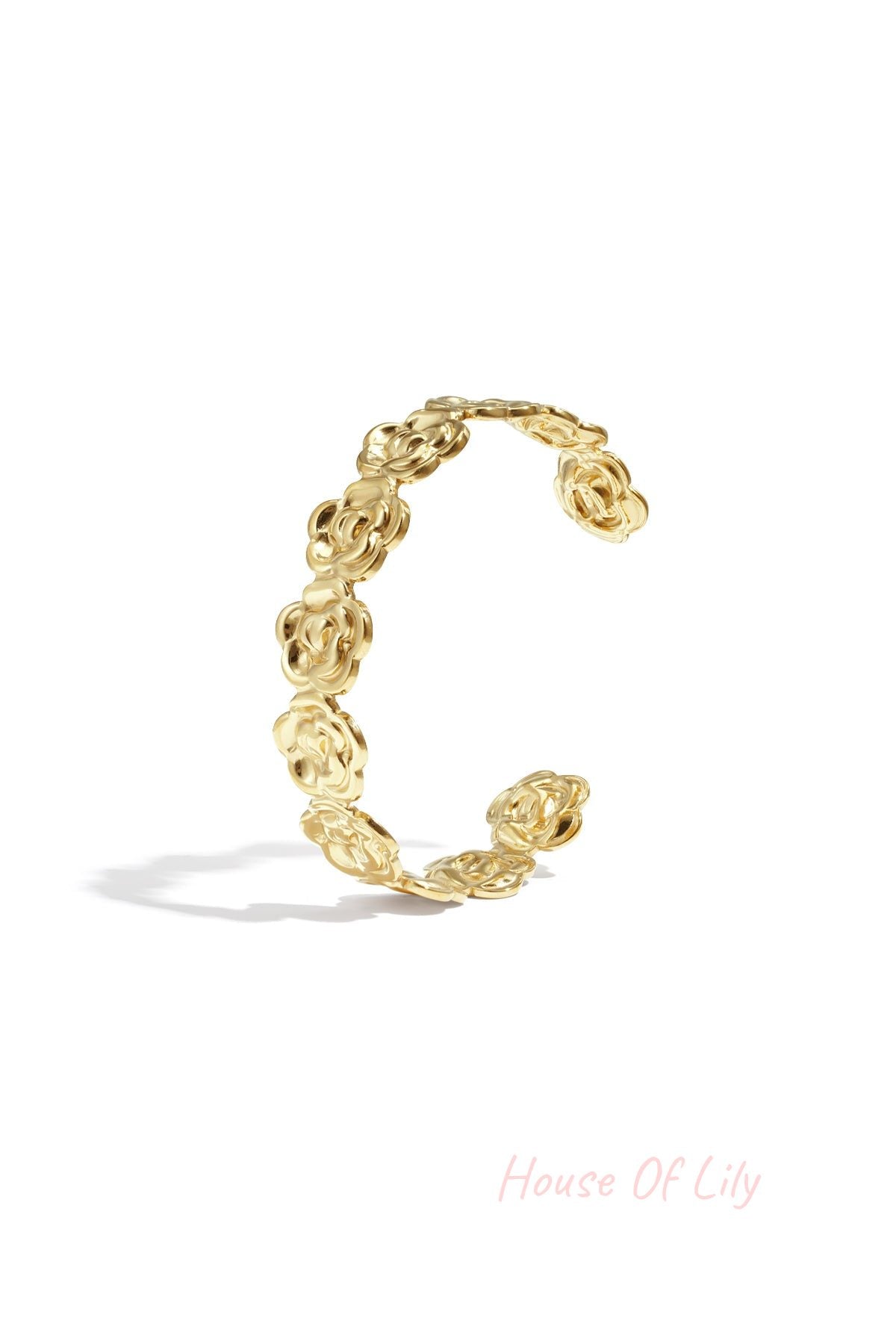 Gold floral cuff bracelet with flower-shaped links displayed on white background