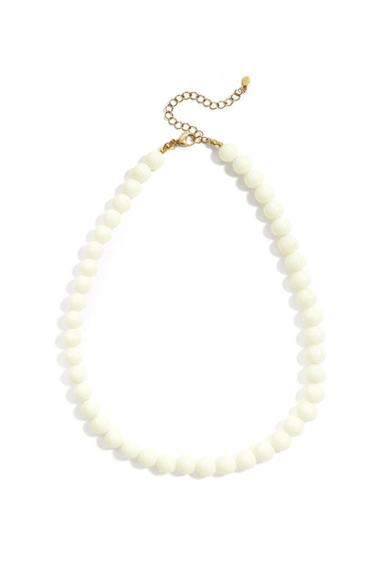 Bright orange resin beaded necklace with gold lobster clasp on white background