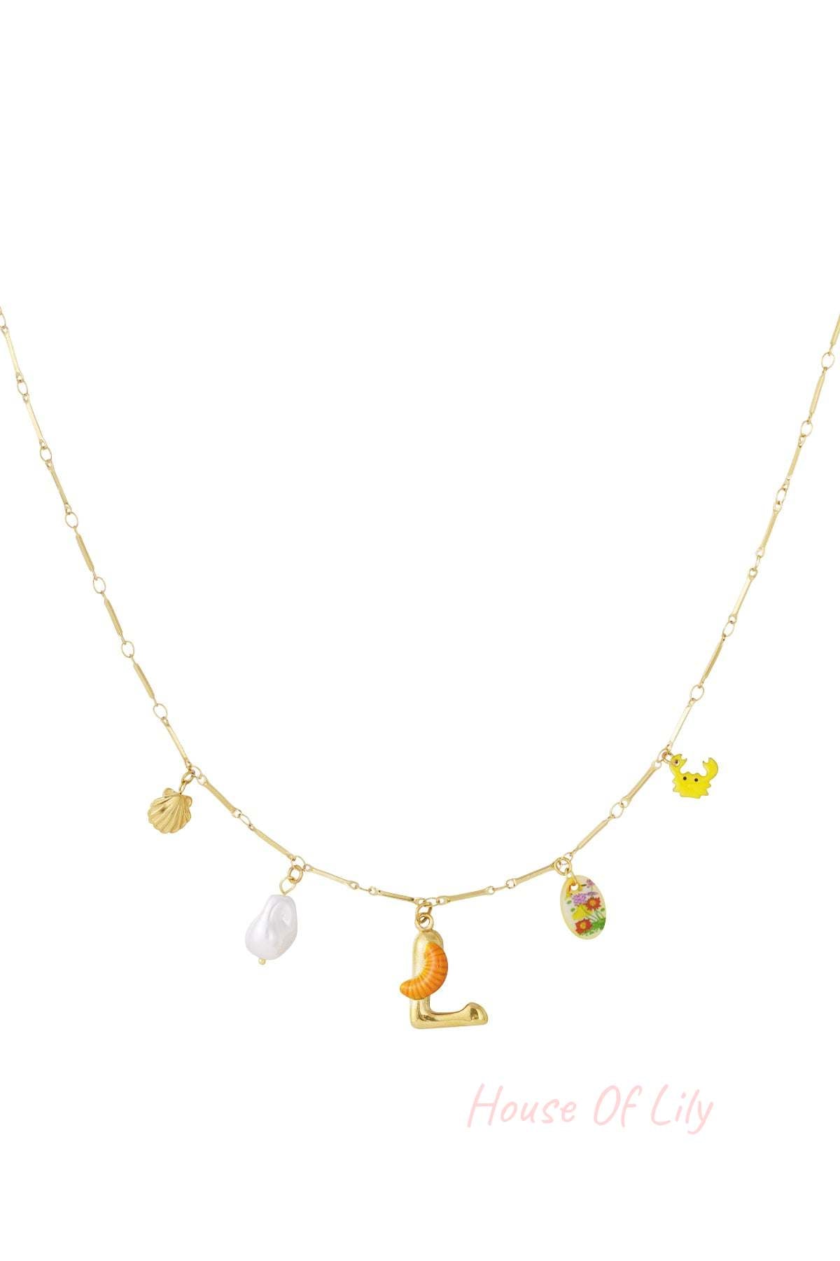 Gold chain necklace featuring an 'L' initial pendant with a small orange slice, pearl, shell, crab, and floral charm.