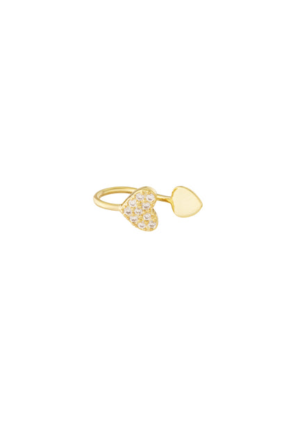 Close-up image of a gold-tone open heart ear cuff with one heart studded with small clear zircon crystals and the other heart smooth polished