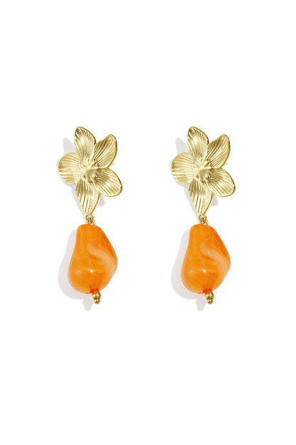 Pair of gold-tone flower drop earrings with vivid pink organic acrylic bead on white background
