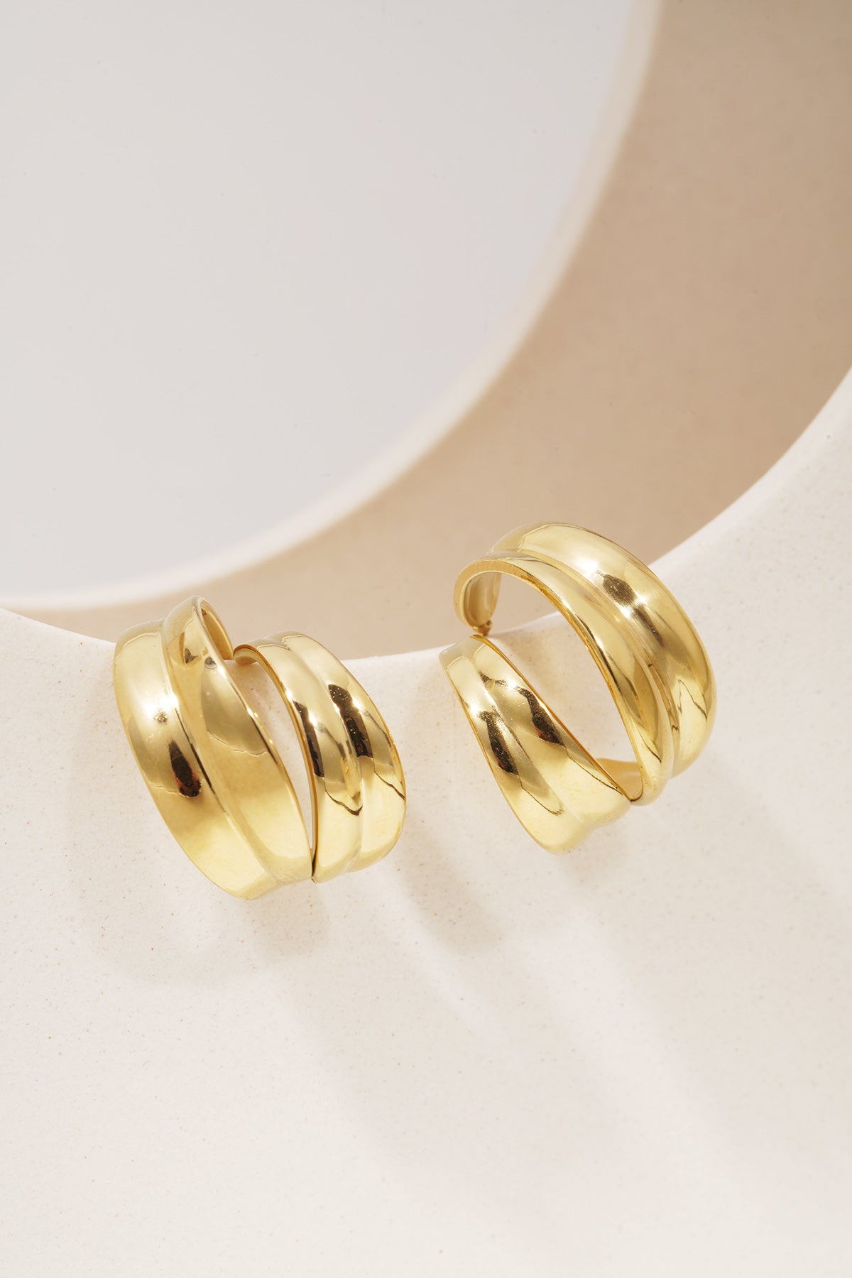 Sculpted Aura Loops: Pair of chunky, gold-plated open hoop earrings with a polished, sculptural, double-layered design.