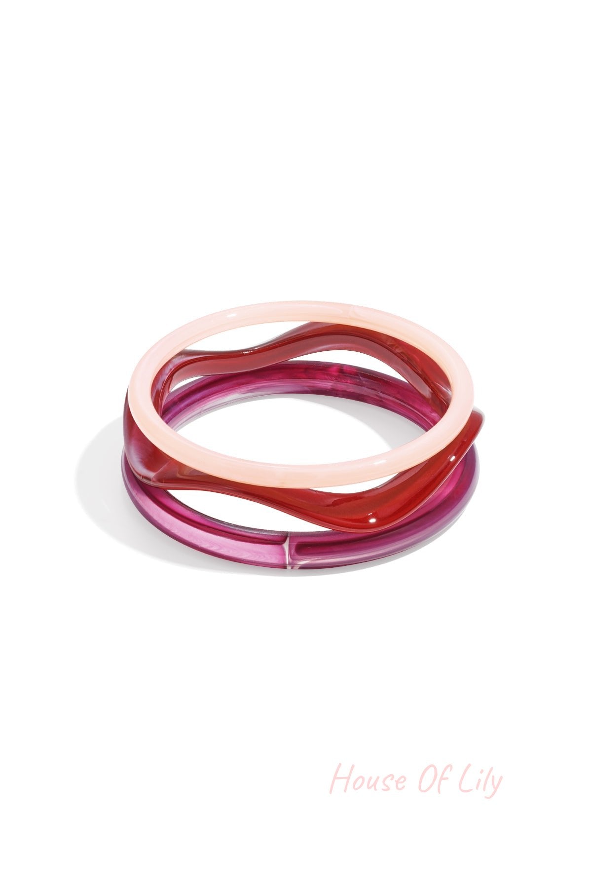 Two acrylic bangles in amber tortoise and clear amber stacked together on white background