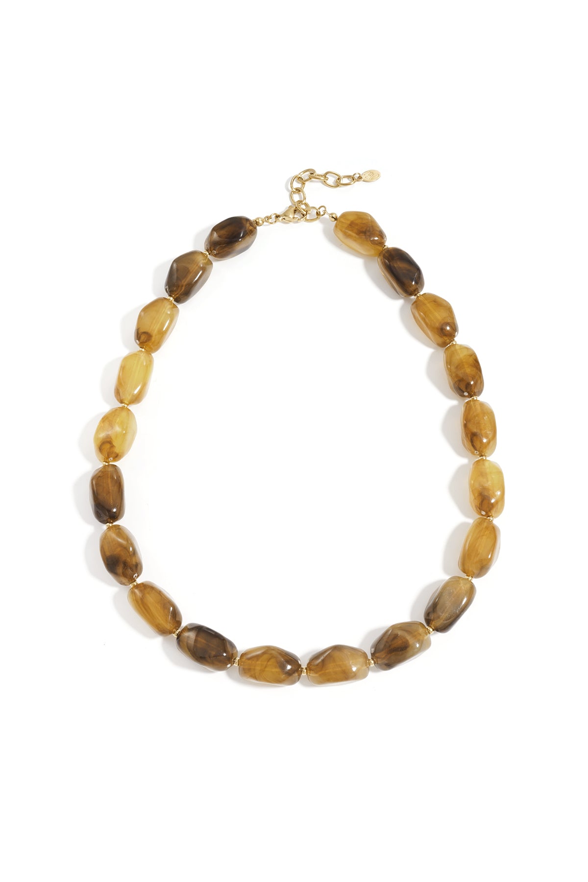 Close-up of chocolate and amber-toned chunky beaded necklace on woman wearing maroon top