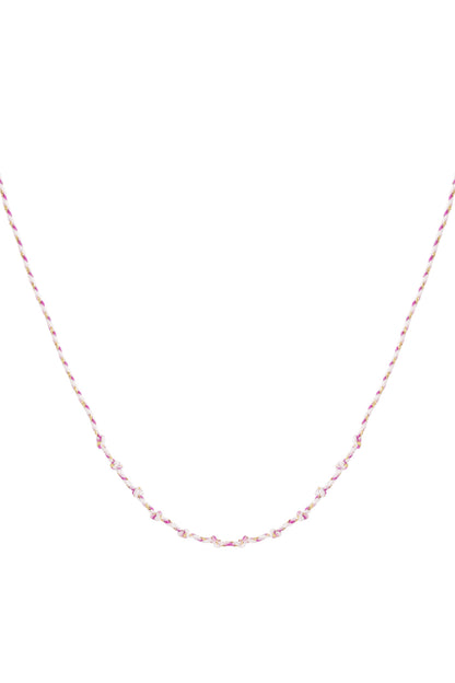 Pink knotted cotton necklace with gold accents laid flat on white background