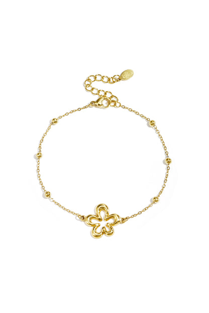 Delicate gold chain bracelet featuring a single open flower charm on white background