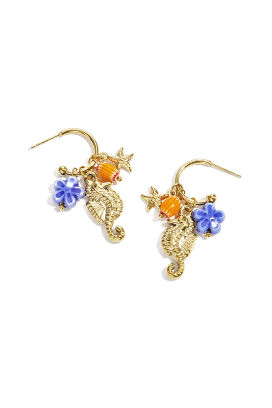Gold-tone hoop earrings with seahorse, starfish, orange bead and blue flower charms