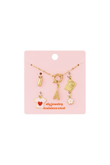 Gold stainless steel chain bracelet kit with assorted Eiffel Tower, camera, heart shirt, and flower charms on pink card.