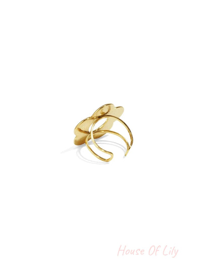 Gold metal ring featuring a textured, abstract floral-shaped top on a split-band base.