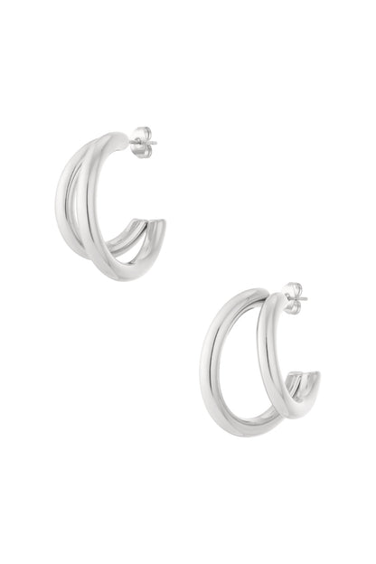 Silver chunky double hoop earrings with smooth polished finish isolated on white background