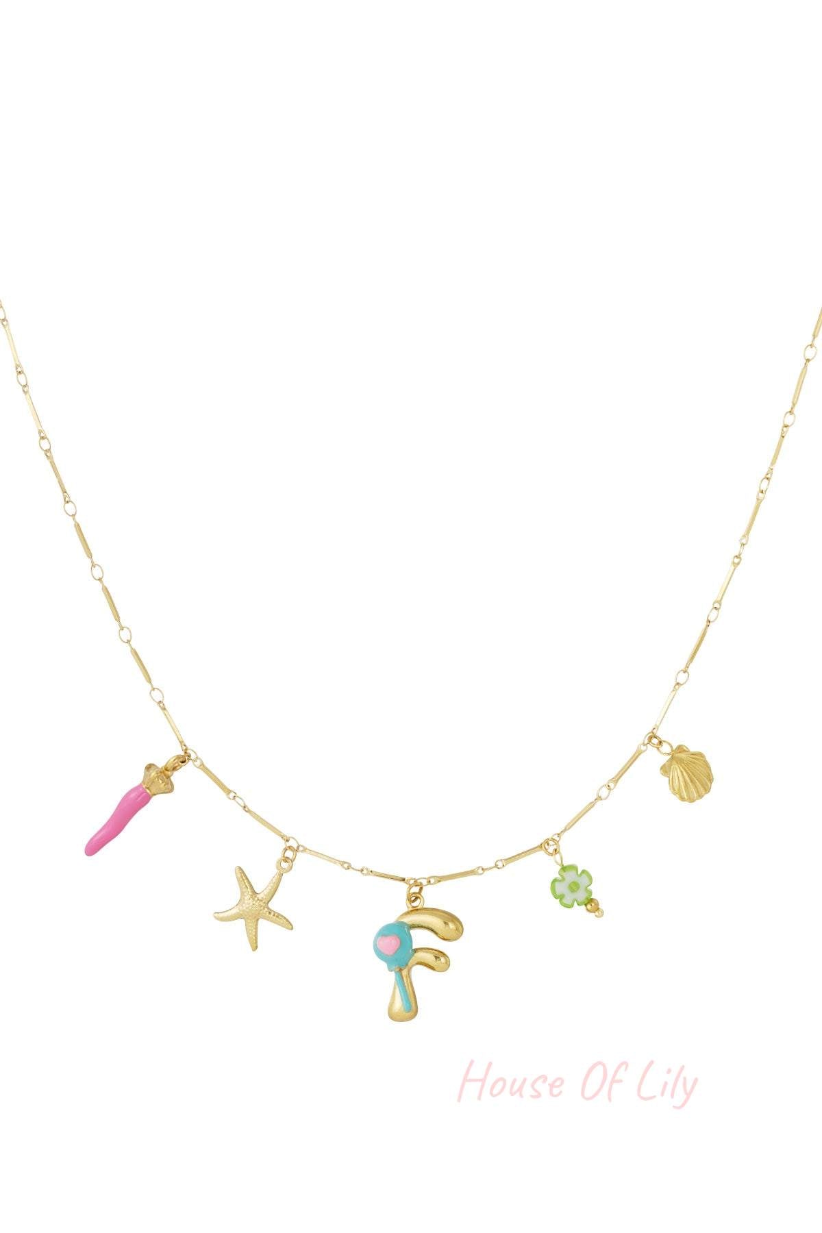 Gold charm necklace with white pearl, red mushroom, pink flower, gold letter J with cherries, and green chili pepper charms