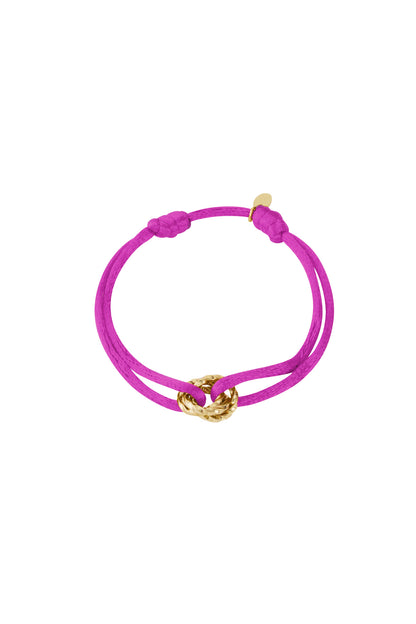 Fuchsia knot charm bracelet with gold-plated twisted knot pendant on white background