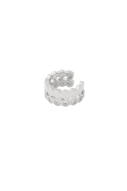 Close-up of a shiny silver geometric ear cuff with zigzag design and embedded crystals