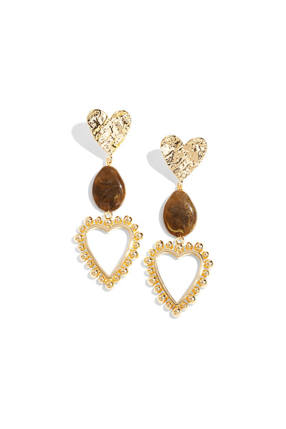 Pair of heart drop earrings with hammered gold heart studs, warm brown resin beads, and gold beaded open heart frames on white background