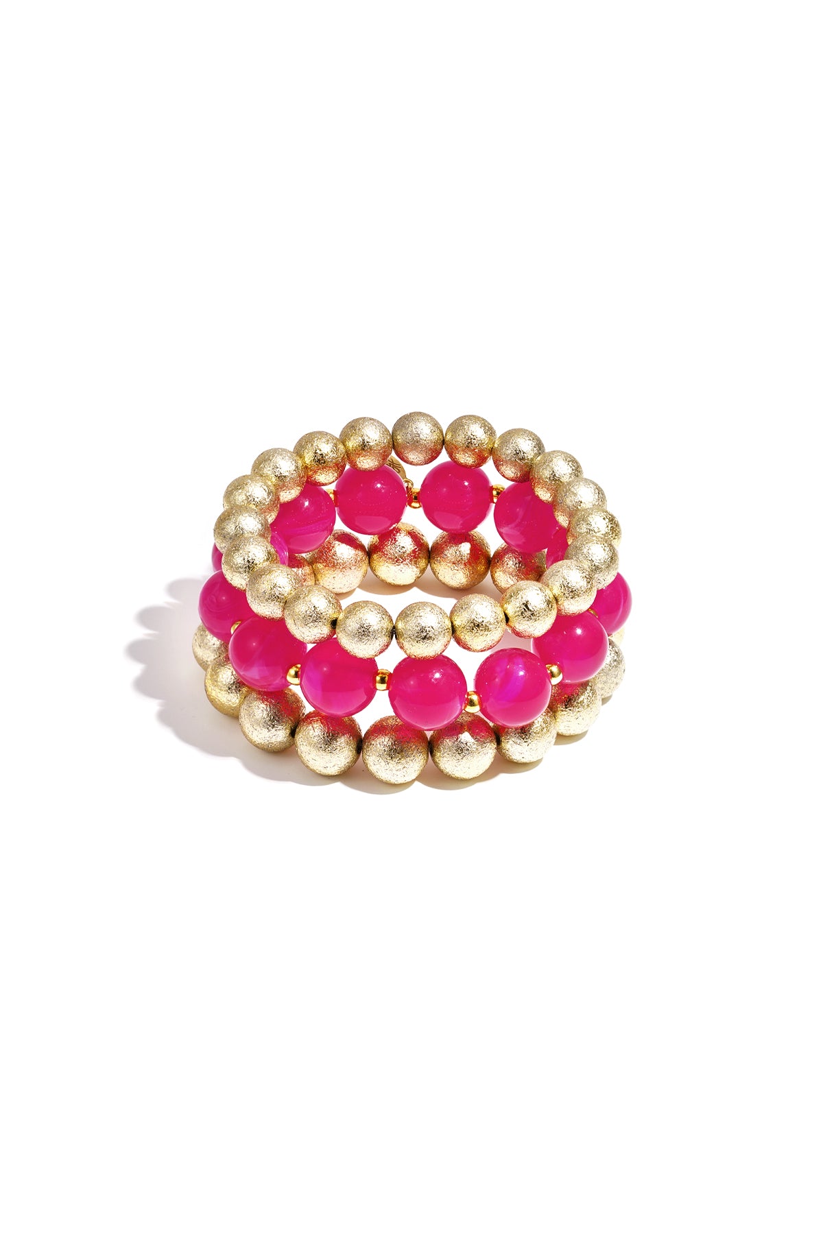 Trio of stretchy beaded bracelets featuring alternating bright pink translucent beads and textured gold-tone spheres.