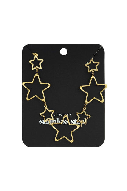 Gold-tone stainless steel necklace featuring multiple open-work star charms of varying sizes on a black display card.