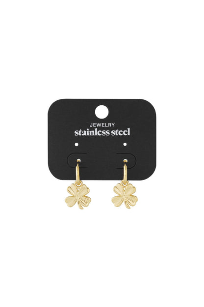 Gold-tone stainless steel hoop earrings featuring dangling four-leaf clover charms on a black display card.