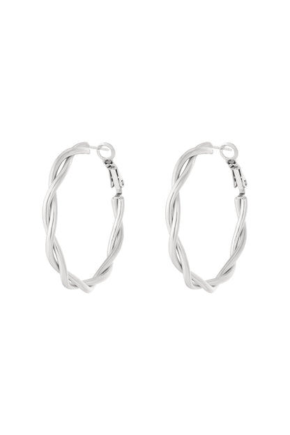 Pair of gold twisted oval hoop earrings, front view on white background