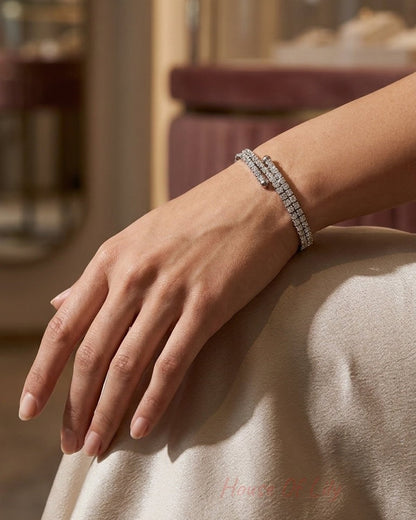 A silver crystal cuff bracelet wrapped around a woman's wrist.