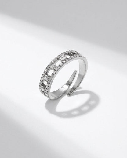 Silver open-band ring with a double row of pavé stones and evenly spaced bezel-set round crystals.