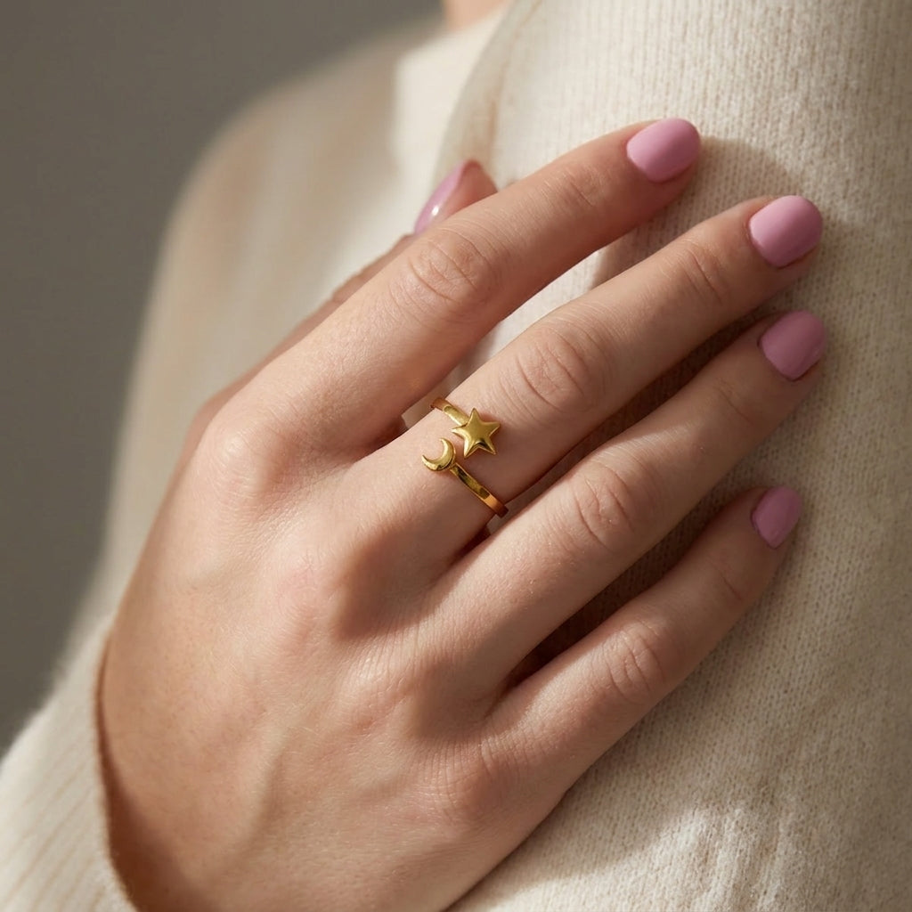 Gold Celestial Mood Ring featuring an open-band design with a small star and crescent moon charm on a hand.
