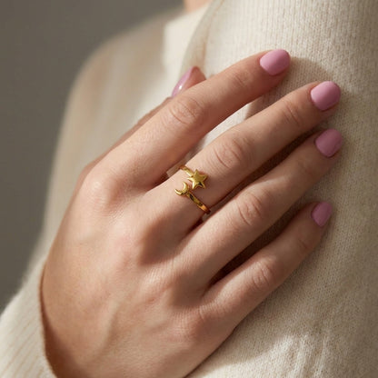 Gold Celestial Mood Ring featuring an open-band design with a small star and crescent moon charm on a hand.