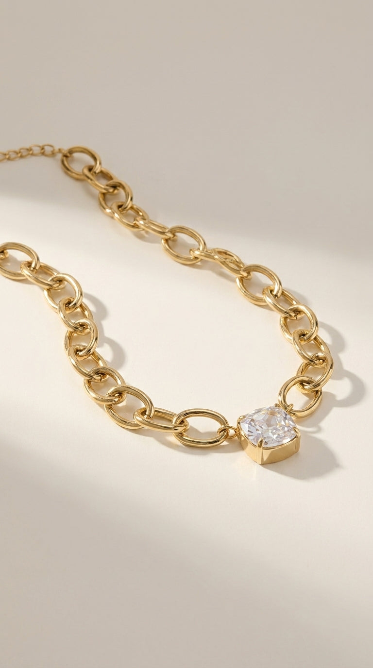 Retro Vibe gold chain necklace featuring a square, prong-set clear crystal pendant against a neutral background.