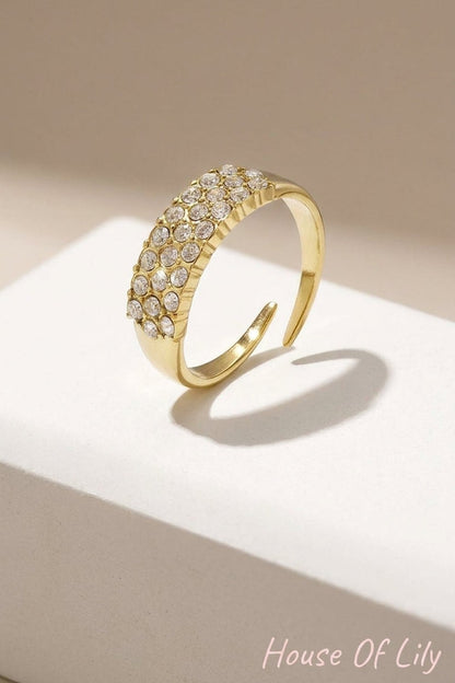 Minimalist gold-tone open ring featuring three rows of embedded rhinestones.