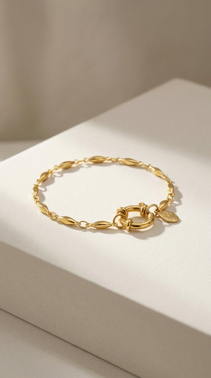 Gold oval chain bracelet with a polished finish and a round spring-ring clasp.