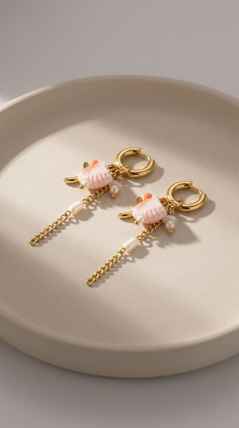 Oceanic Gold Drop Earrings featuring gold hoops, pink shell charms, small pearls, and dangling chains.