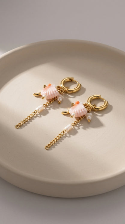 Oceanic Gold Drop Earrings featuring gold hoops, pink shell charms, small pearls, and dangling chains.