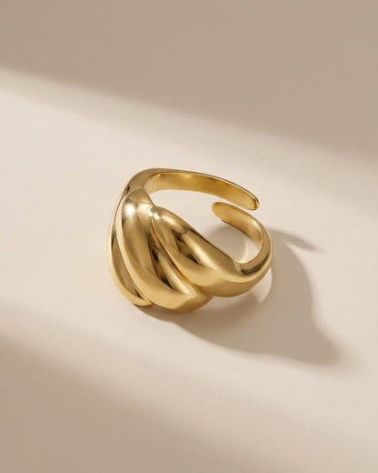 Bold gold statement ring featuring three rounded, puffy segments in a polished finish.