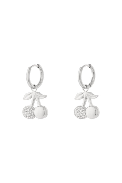 Pair of silver cherry drop earrings with rhinestone accents dangling from hoop earrings on white background