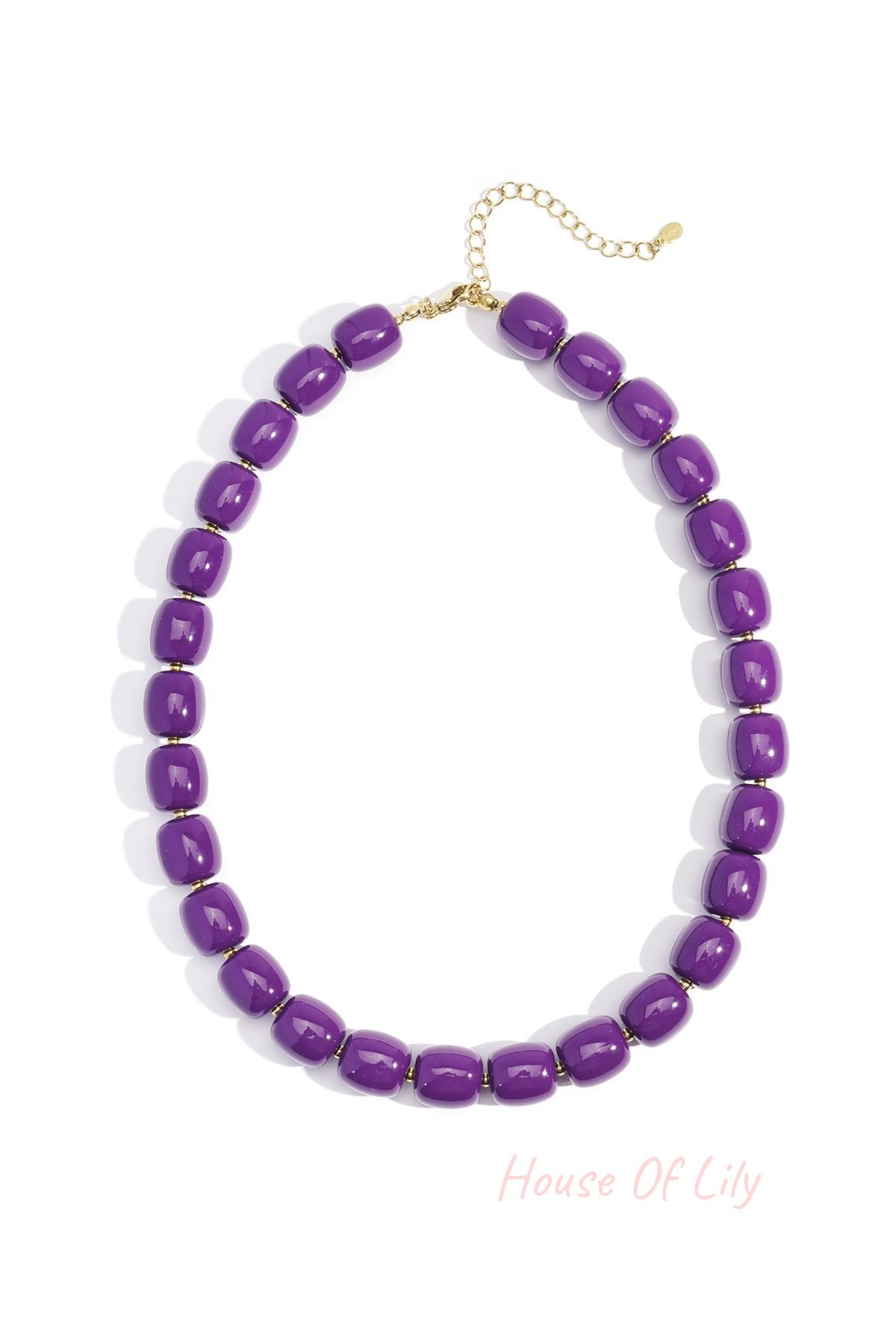 Close-up of purple chunky acrylic bead necklace with gold-tone chain extension on white background