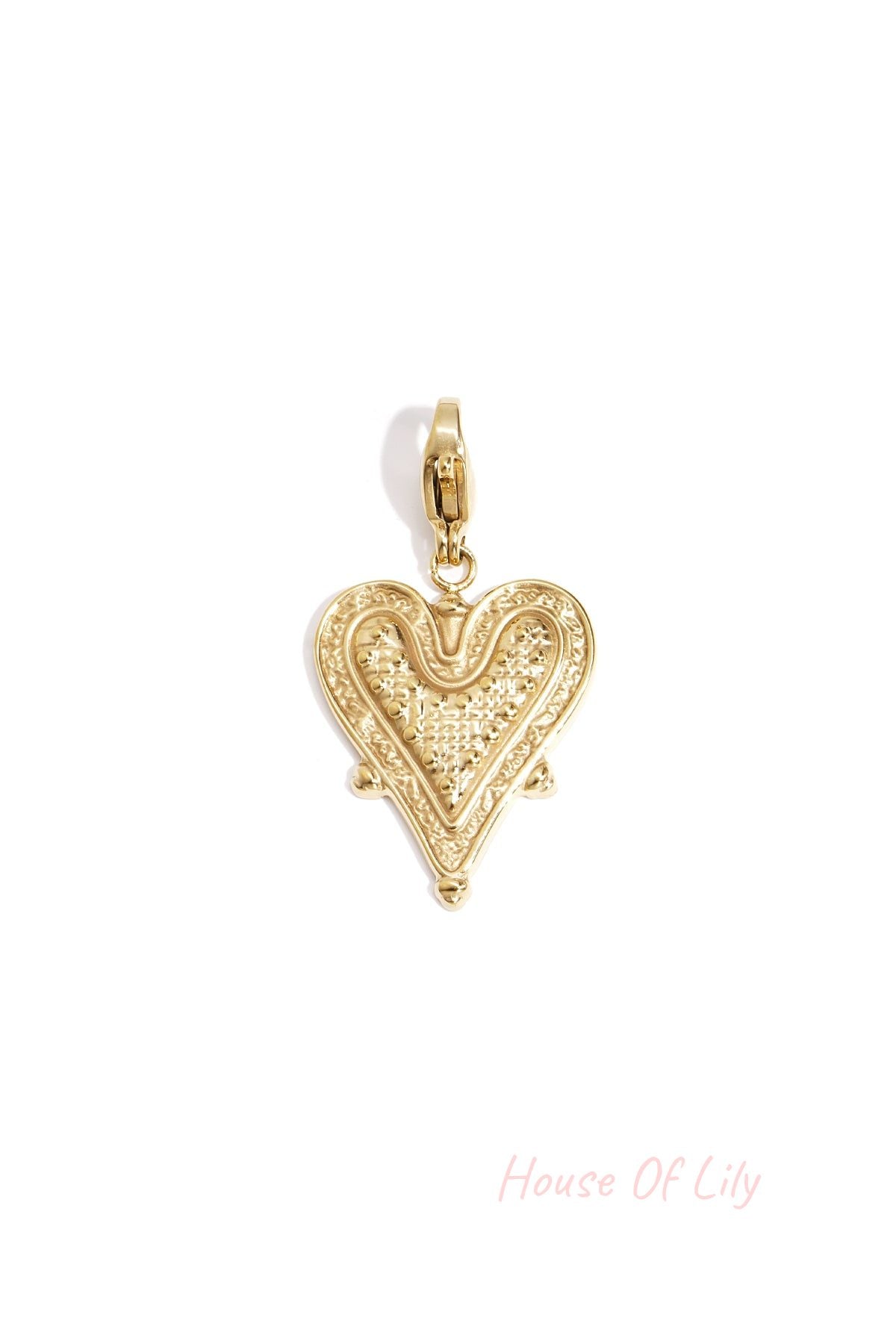 Close-up of a gold textured heart-shaped charm with a lobster clasp on a white background