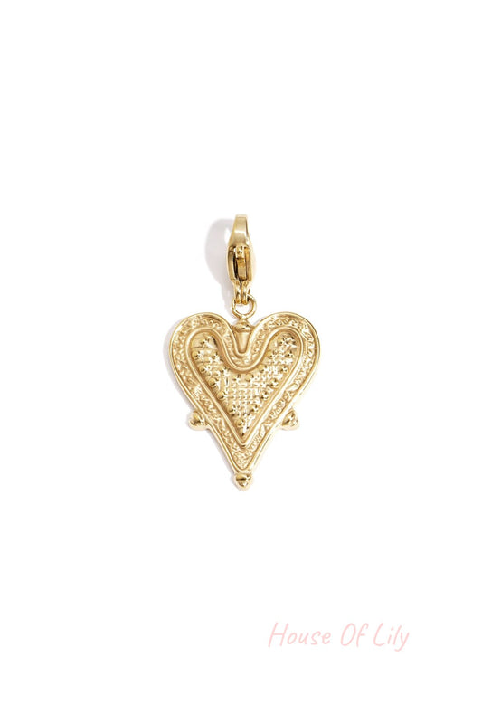 Close-up of a gold textured heart-shaped charm with a lobster clasp on a white background