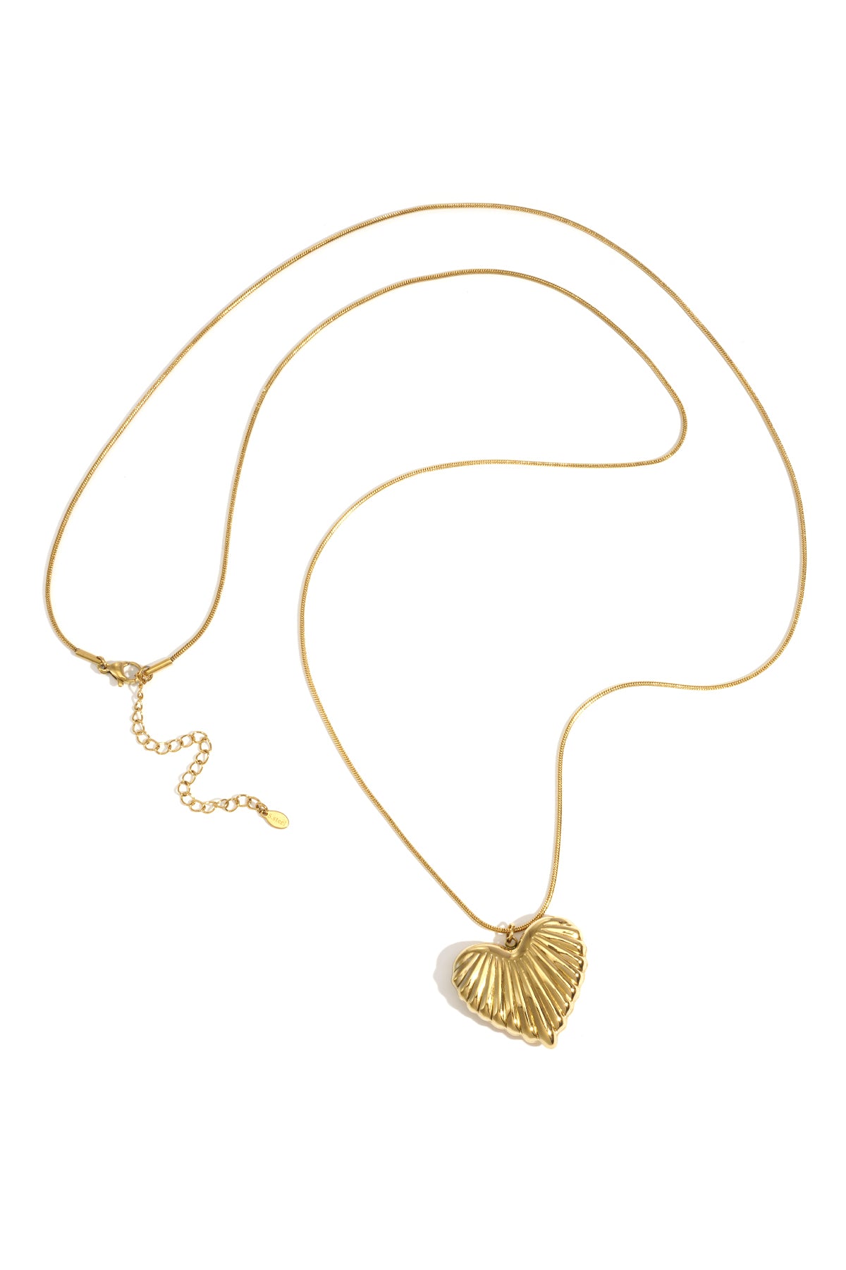 Gold long necklace with a ridged heart-shaped pendant on white background