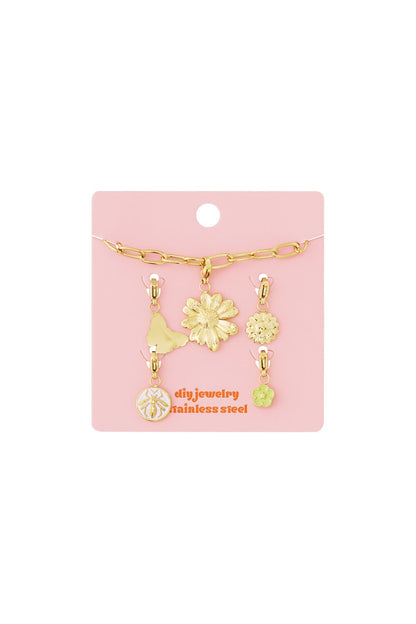 Gold stainless steel link bracelet on a pink card with floral, butterfly, and bee-themed charms.