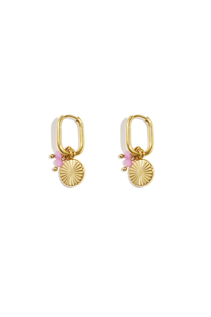 Pair of gold rectangular hoop earrings with sunflower charm and light pink beads on white background