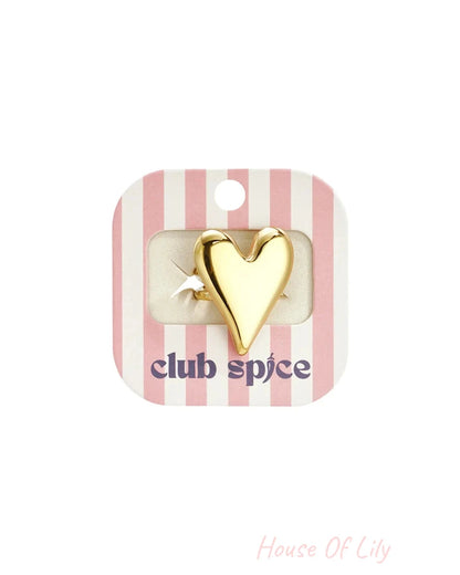 Gold heart ring on pink striped packaging with “club spice” in purple.