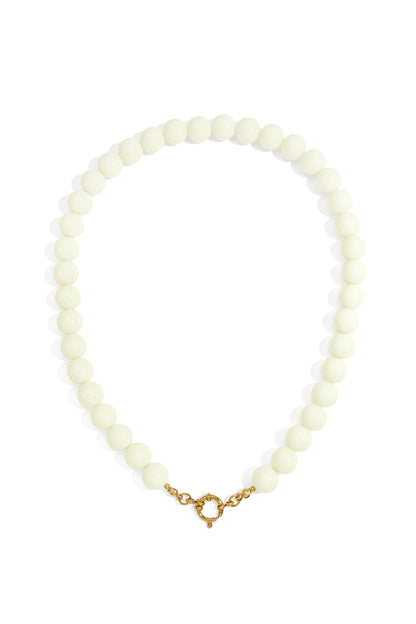 Cream-colored resin beaded necklace on a white background, featuring a round gold spring ring clasp.