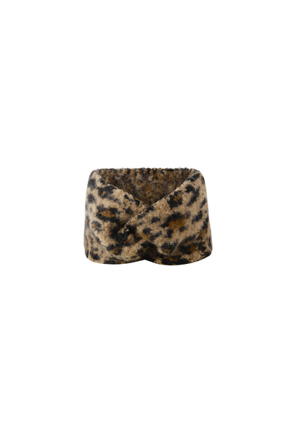 Front view of a soft, fuzzy leopard print headband with a twisted front design on white background