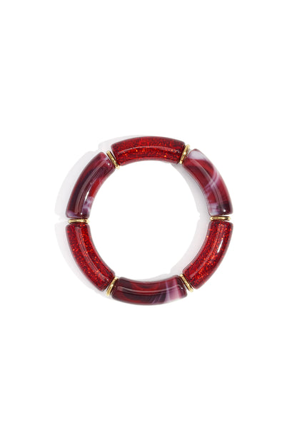 Red glitter and marbled resin beaded stretch bracelet with gold-tone spacers on white background