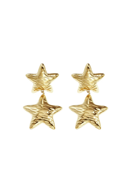 Pair of shiny gold star-shaped double drop earrings with hammered texture on white background