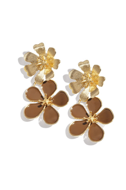 Pair of gold-tone drop earrings with textured top flower and coffee brown enamel bottom flower on white background