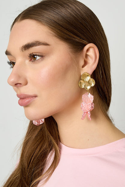 Gold flower drop earrings with pink cascading petals displayed on earring card against white backdrop
