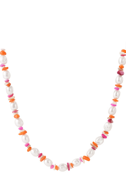 Close-up of colorful pearl and mixed pink orange bead necklace laid flat
