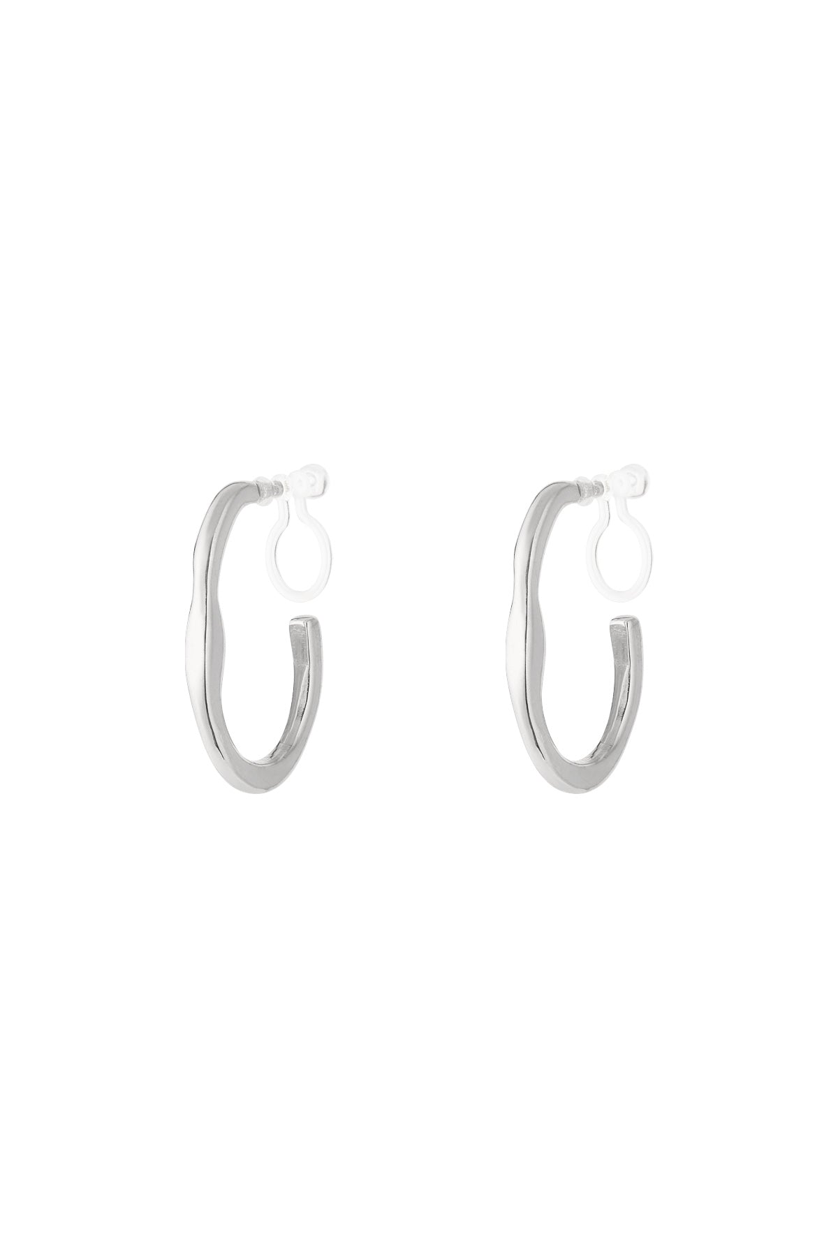 Pair of silver irregular wave-shaped clip-on hoop earrings with clear clip backs on white background