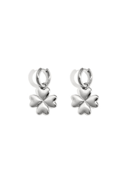 Pair of silver four-leaf clover hoop earrings with heart-shaped petals on white background