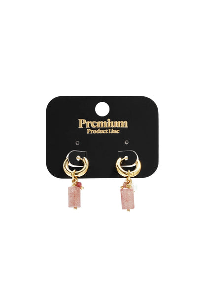 Gold hoop earrings featuring dangling rectangular pink stone beads and smaller accent charms on a black display card.